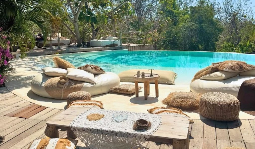 Outdoor view of La Cabane boutique hotel with rustic wooden bungalows